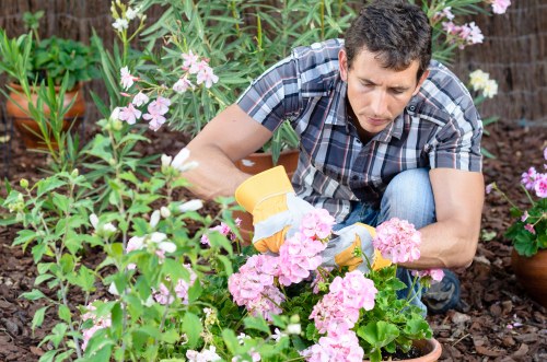 Staff using protective equipment during gardening tasks